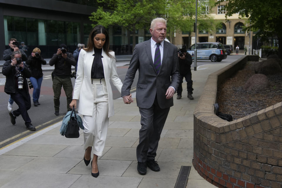 Former Tennis player Boris Becker with Lilian de Carvalho Monteiro as they arrive at Southwark Crown Court for sentencing in London, Friday, April 29, 2022. Becker was found guilty earlier of dodging his obligation to disclose financial information to settle his debts.(AP Photo/Alastair Grant)