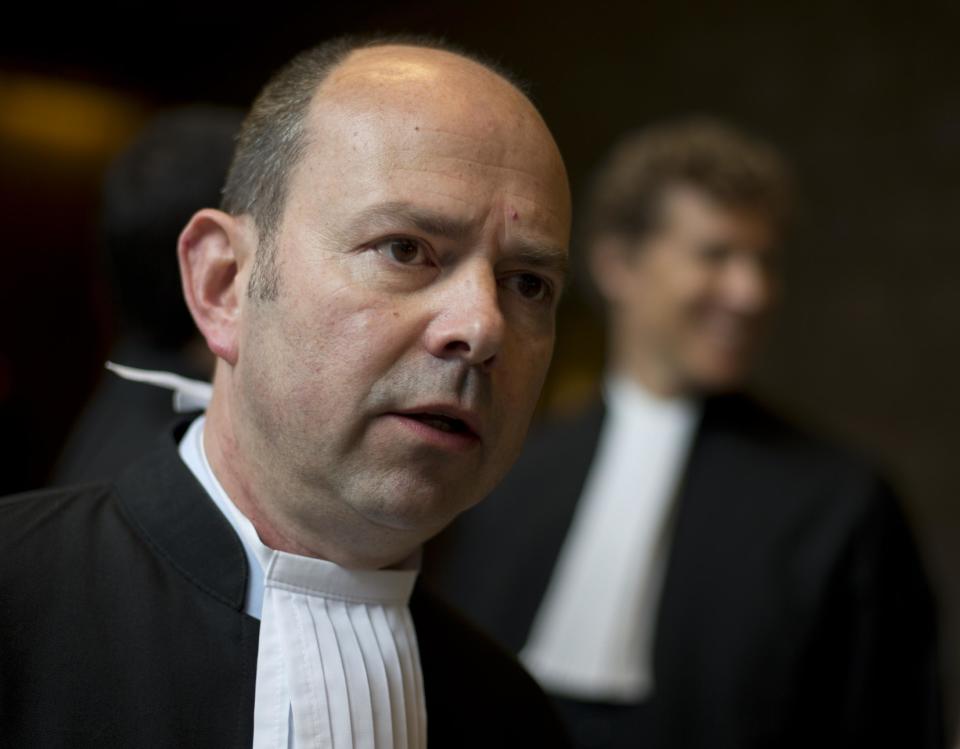 Marco Gerritsen, lawyer for a group of women from the Bosnian town of Srebrenica, answers questions from a journalist prior to the start of a court case in The Hague, Netherlands, Monday, April 7, 2014. Mothers and widows of men murdered in Europe's worst massacre since World War II are suing the Dutch government for failing to protect their husbands and sons during the 1995 Srebrenica genocide. The civil case starting Monday in the courtroom focuses on the failure of Dutch troops serving as United Nations peacekeepers to protect Muslim men in the protected enclave in eastern Bosnia from rebel Serbs who overran the town and killed some 8,000 men and boys. (AP Photo/Peter Dejong)