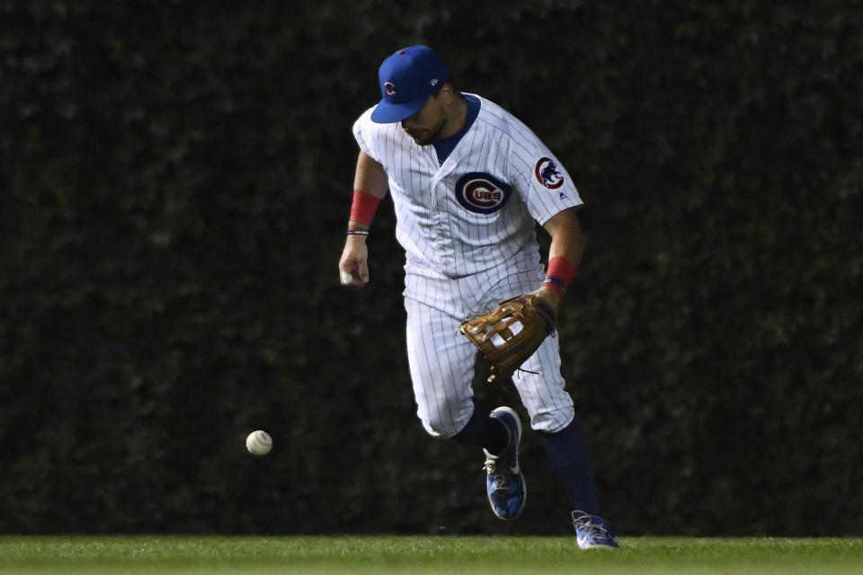 Chicago Cubs left fielder Kyle Schwarber makes a fielding error on an RBI-single hit by St. Louis Cardinals' Yadier Molina during the sixth inning of a baseball game Thursday, Sept. 19, 2019, in Chicago. (AP Photo/Matt Marton)