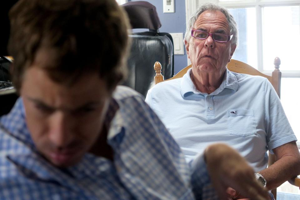 Frank Kineavy watches as his son Frankie, who was recently named Sea Girt's Citizen of the Year, works with his scribe Andrew Schwaeber (not shown) in his Sea Girt home.