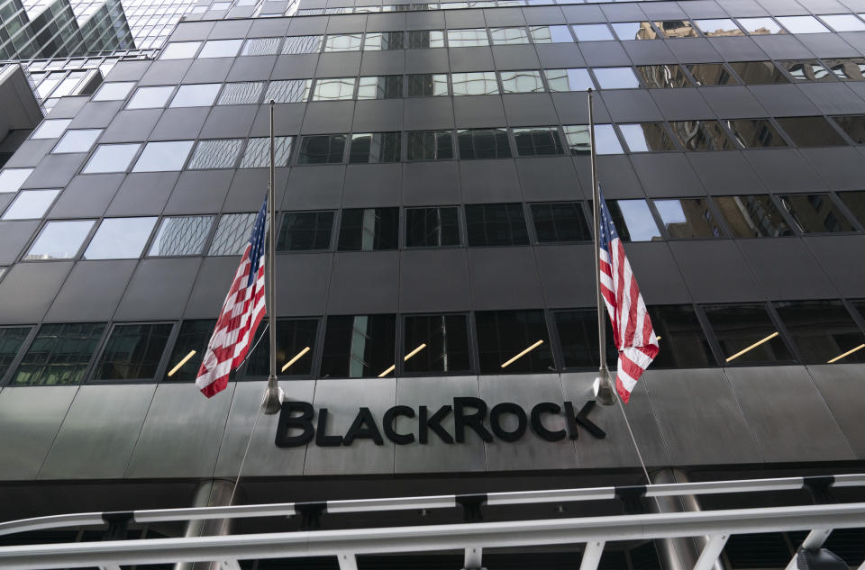 FILE -Flags fly on the front of BlackRock headquarters, Wednesday, Jan. 13, 2021, in New York. Asset manager BlackRock is buying independent infrastructure fund manager Global Infrastructure Partners in a cash-and-stock deal valued at more than $12 billion. The deal announced Friday, Jan. 12, 2024, includes $3 billion in cash and approximately 12 million shares of BlackRock. (AP Photo/Mark Lennihan, File)