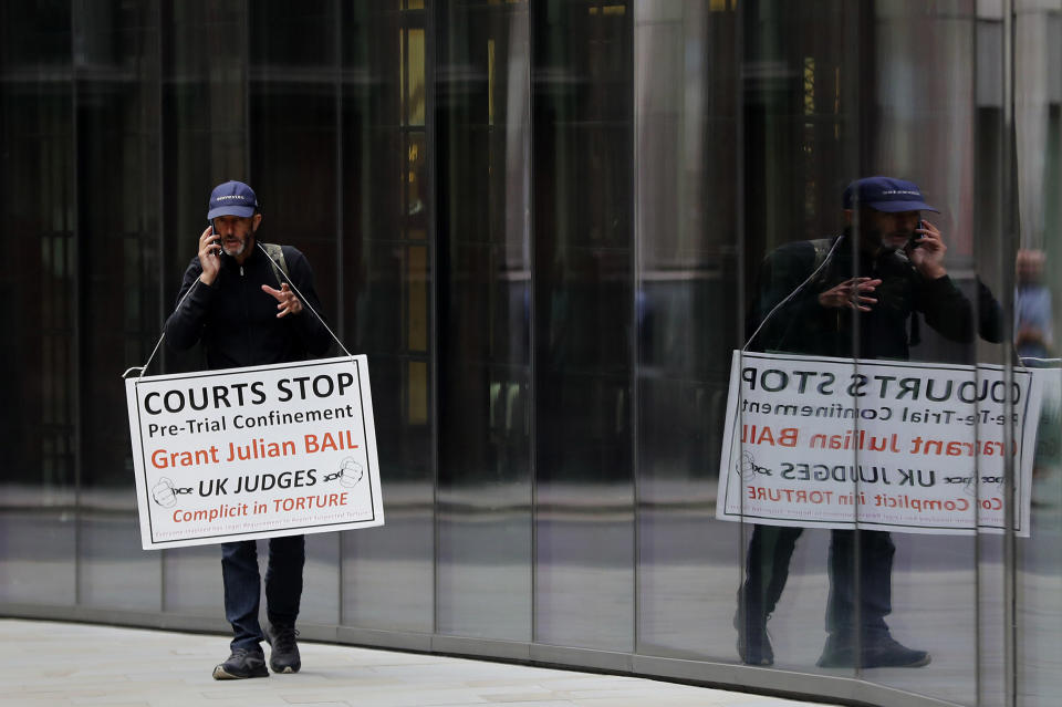 Image: A protester stands opposite London's Old Bailey court on Monday as the Julian Assange extradition hearing to the U.S. continued. (Frank Augstein / AP)
