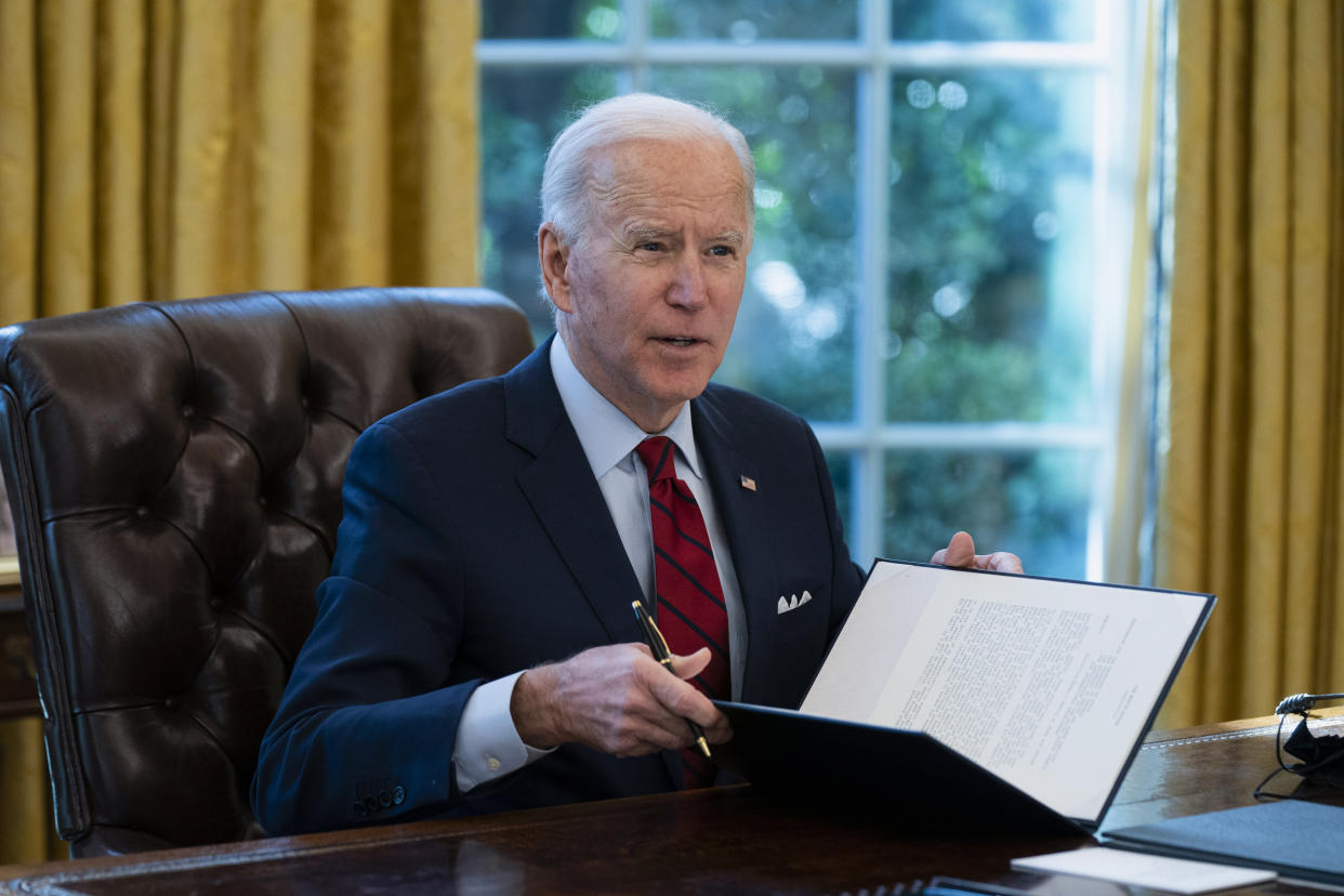 President Joe Biden signs a series of executive orders on health care, in the Oval Office of the White House on Jan. 28, 2021, in Washington. (Evan Vucci/AP)   