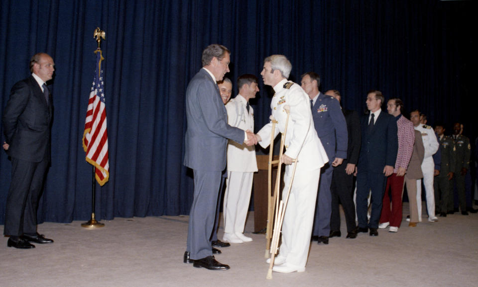 Then-President Richard Nixon greets former Vietnam prisoner of war John McCain at a pre-POW dinner reception in Washington on May 24, 1973.