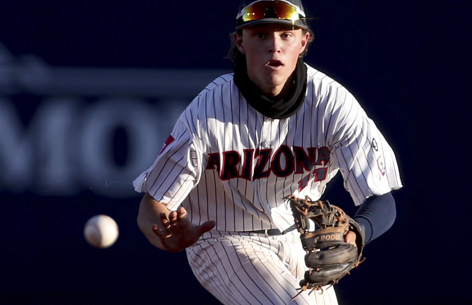 Arizona shortstop Nik McClaughry tracks down a roller up the middle by Mississippi's Hayden Dunhurst for the out during the second inning in an NCAA college baseball tournament super regional game Friday, June 11, 2021, in Tucson, Ariz. (Kelly Presnell/Arizona Daily Star via AP)