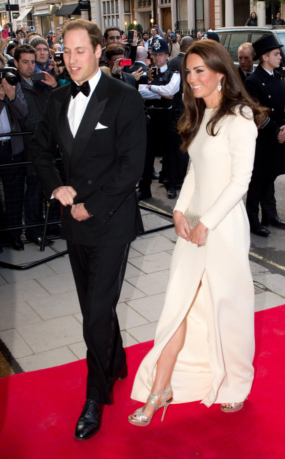 <p>Kate donned a chic white Roland Mouret evening gown for a dinner at Claridge’s. She wore her favourite gold Jimmy Choos and opted for a beaded vintage clutch.</p><p><i>[Photo: PA]</i></p>