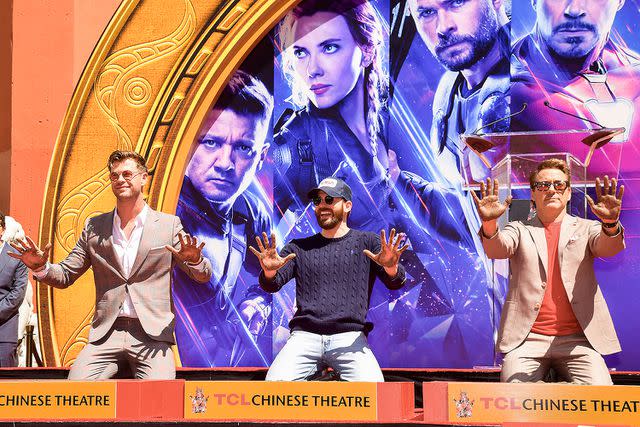 <p>Matt Winkelmeyer/Getty </p> Chris Hemsworth, Chris Evans and Robert Downey Jr. get their hand prints cemented at TCL Chinese Theatre in 2019