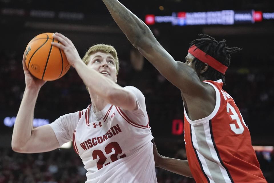 Wisconsin's Steven Crowl shoots past Ohio State's Felix Okpara during the second half of an NCAA college basketball game Tuesday, Feb. 13, 2024, in Madison, Wis. (AP Photo/Morry Gash)