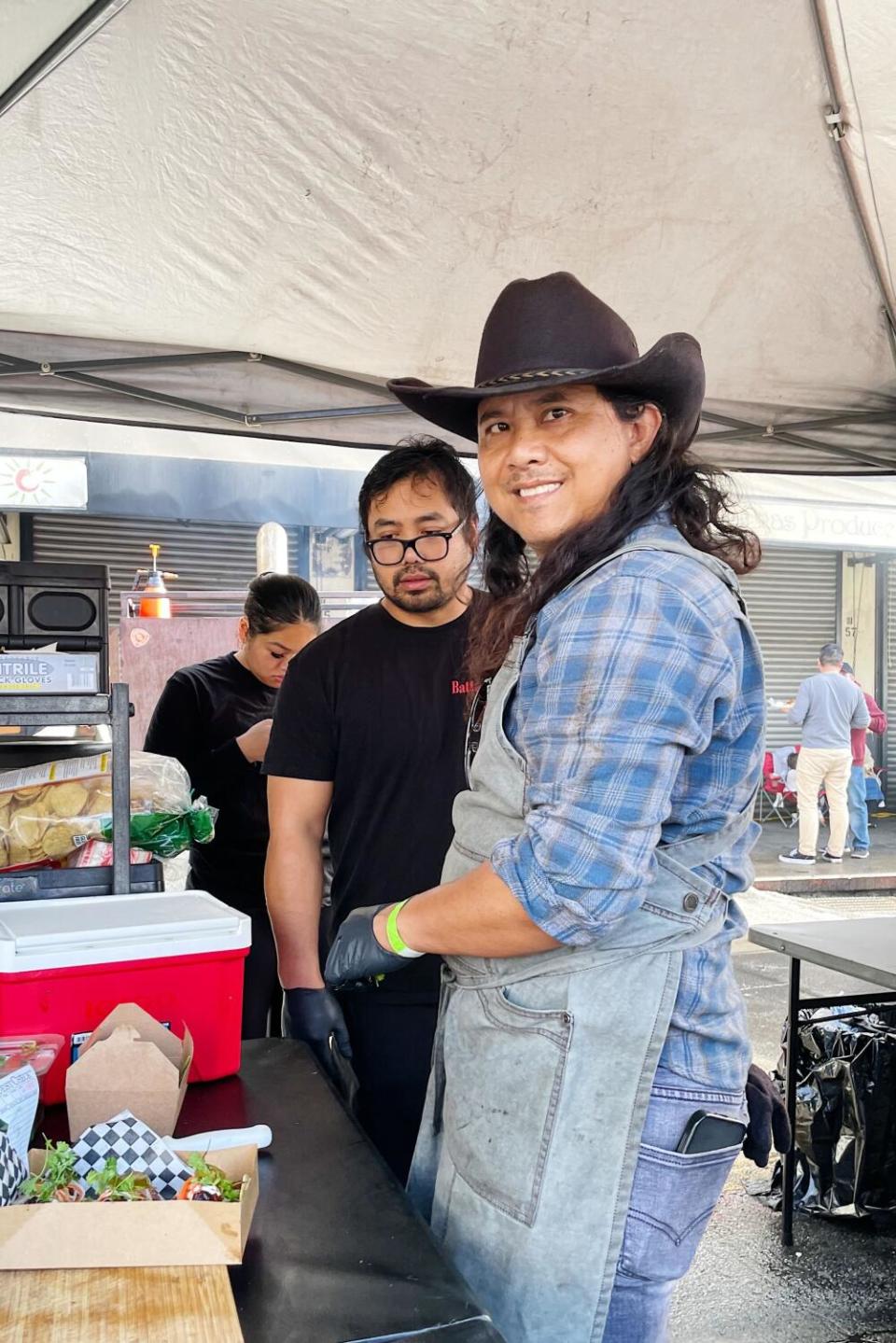 Chad Phuong readies an order at his Battambong BBQ booth at Smorgasburg.