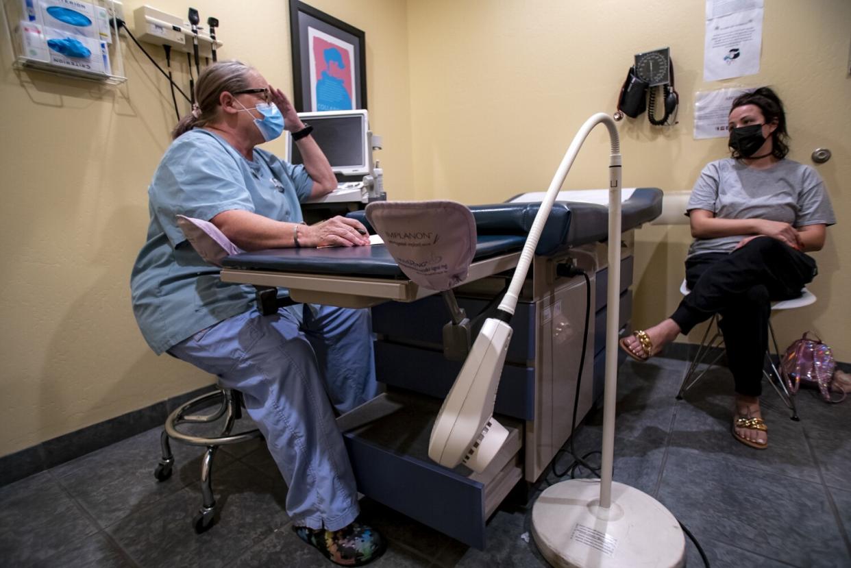 A nurse talking to a patient