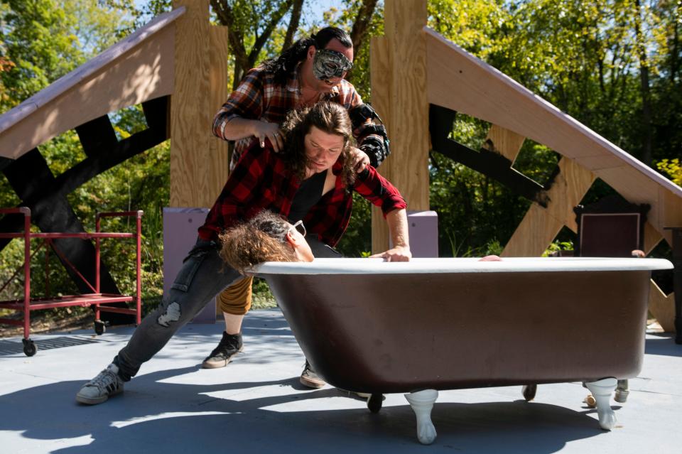 Robert Neal, playing the creature (with the mask on), throws Caleb Johnson, portraying Victor Frankenstein, across the stage and forces him to look down at Elizabeth, portrayed by Tessa Leuchtefeld, in a bath tub during a rehearsal for the play "Frankenstein" at the "It's Alive" production at Haunted Mountain on September 21, 2023, in Chillicothe, Ohio.