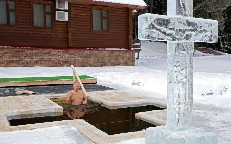 Mr Putin on Tuesday took an ice bath to mark the Epiphany  - Sputnik/Mikhail Klimentyev/Kremlin via REUTERS