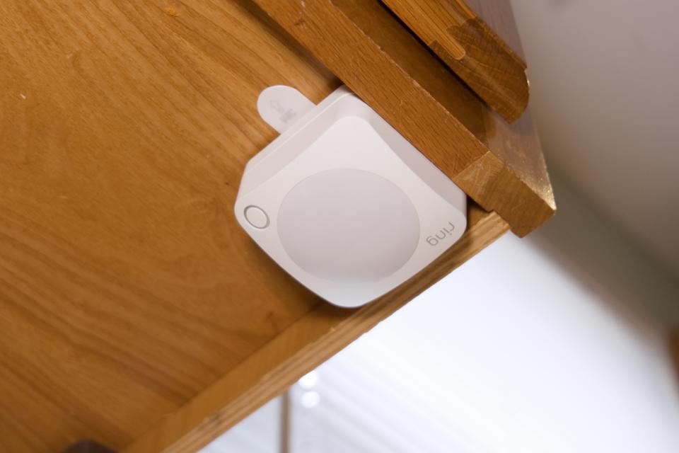 Closeup of Ring Alarm Motion Detector attached to cabinet used as a cat deterrent.