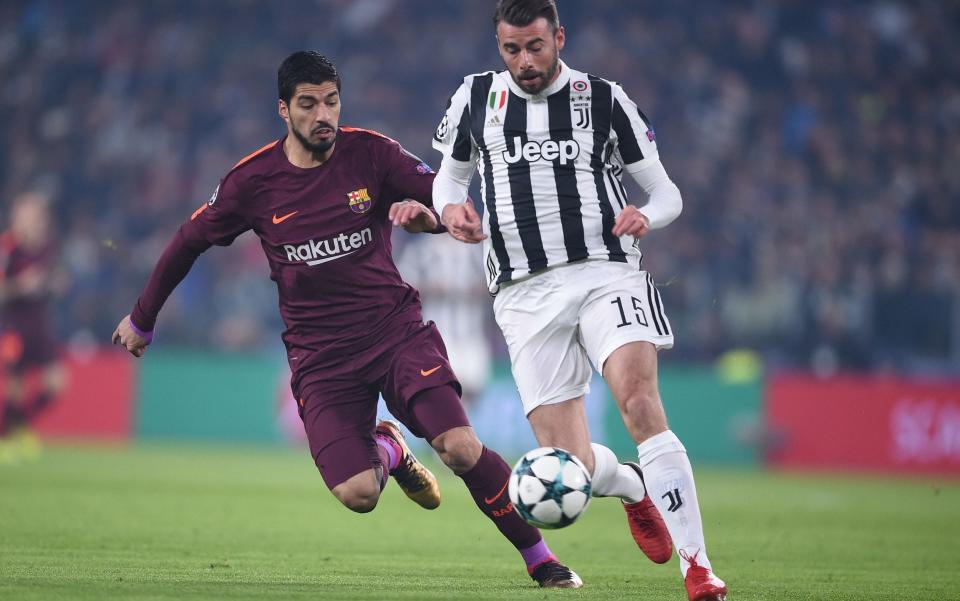 Andrea Barzagli of Juventus closes down Barcelona's Luis Suarez - AFP