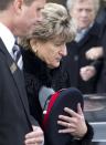 Vicky Zivcic, mother of police constable John Zivcic, leaves the public memorial for John while carrying his hat in Toronto December 9, 2013. Zivcic died December 2, from injuries he sustained in a car crash while in pursuit of another vehicle. He was Toronto's 26th officer to die while on duty since the Toronto police force began in 1957. REUTERS/Fred Thornhill (CANADA - Tags: OBITUARY CRIME LAW)