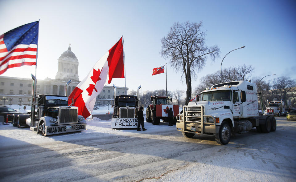 Demonstrators rally against provincial and federal COVID-19 vaccine mandates and in support of Ottawa protestors, Friday, Feb. 4, 2022, outside the Manitoba Legislature in Winnipeg, Manitoba. (John Woods/The Canadian Press via AP)