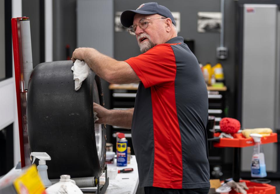 Tom Drake works on detailing a magnesium rim, Wednesday, May 4, 2022, in a room called The Basement Collection, in the Indianapolis Motor Speedway’s museum. 