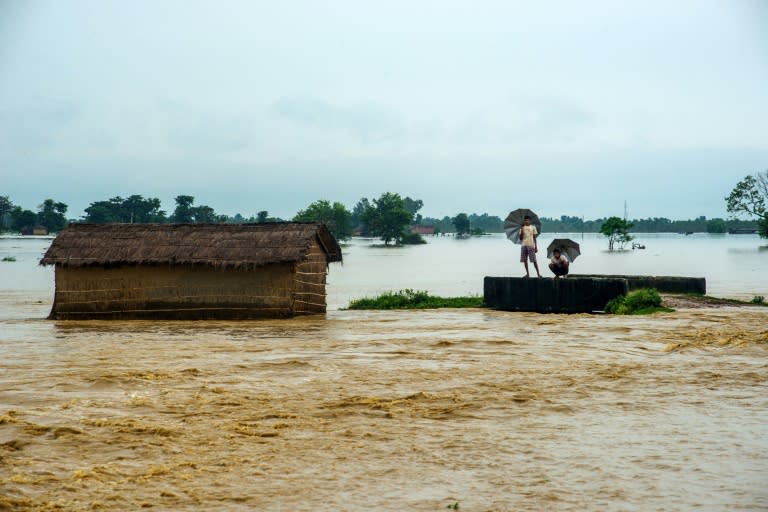 Nepali residents look at the water in a flooded area in the Birgunj Parsa district, some 200km south of Kathmandu