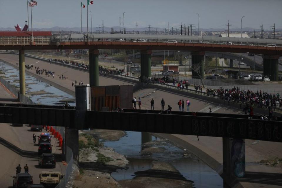 Migrantes, en su mayoría de origen venezolano, intentan cruzar por la fuerza a Estados Unidos en el Puente Internacional Paso del Norte en Ciudad Juárez, estado de Chihuahua, México, el 12 de marzo de 2023.