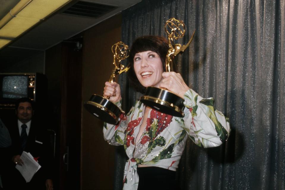 <p>Actress/comedian Lily Tomlin poses with her dual Emmy trophies that she received for her self-titled special, <em>Lily.</em></p>