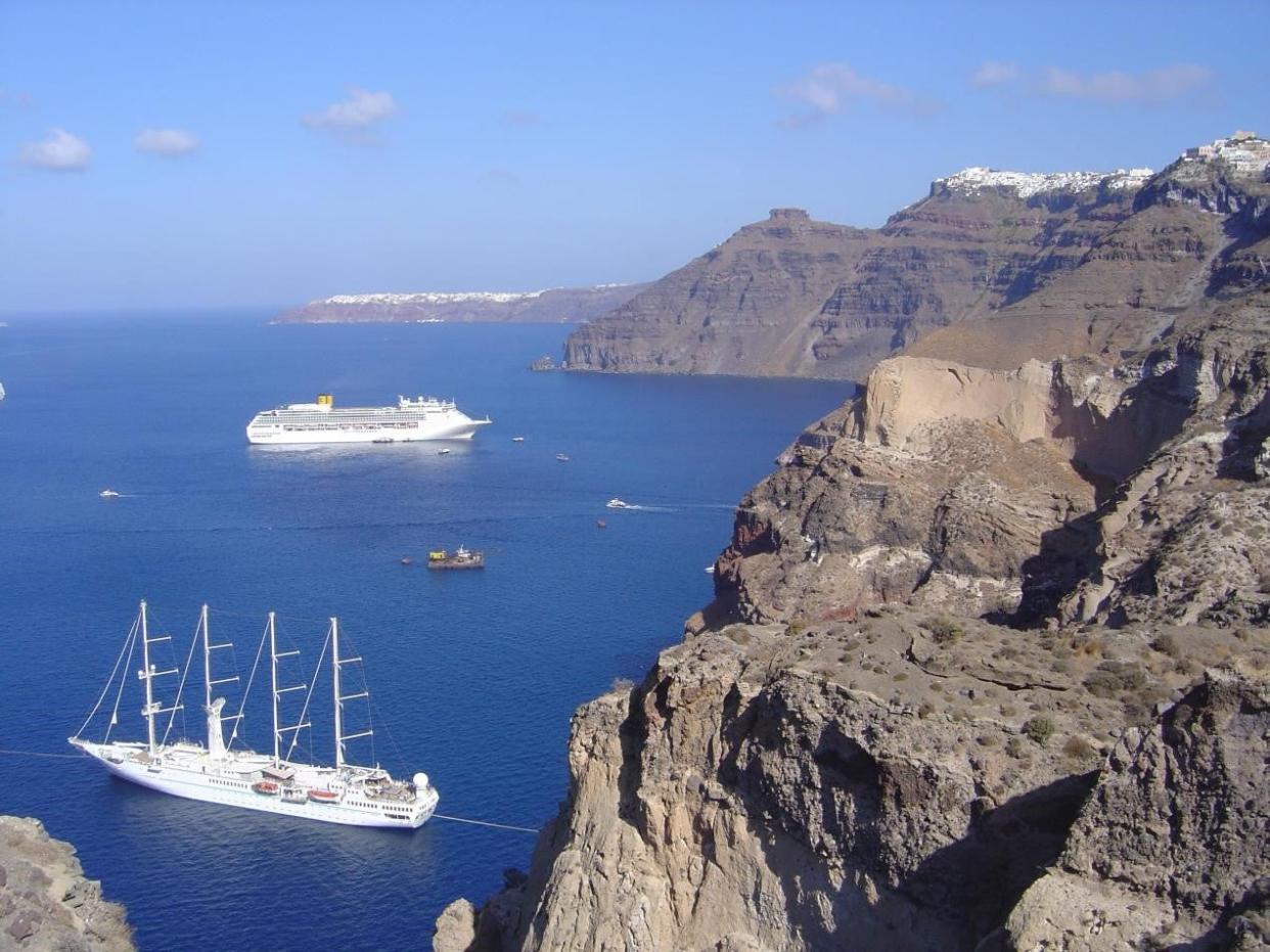 The cliffs of the volcanic island of Santorini, which show the layers of deposits from past volcanic eruptions (Dr Ralf Gertisser/Keele University/PA)