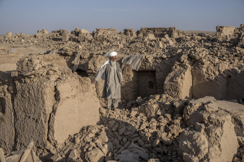 An Afghan man stands amid destruction after an earthquake in Zenda Jan district in Herat province, western Afghanistan, Wednesday, Oct. 11, 2023. Another strong earthquake shook western Afghanistan on Wednesday morning after an earlier one killed more than 2,000 people and flattened whole villages in Herat province in what was one of the most destructive quakes in the country's recent history. (AP Photo/Ebrahim Noroozi)