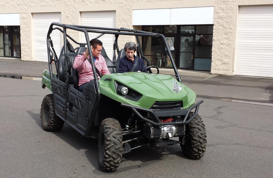 Bob Simpson takes Milton for a spin in EVDrive's torque-vectoring UTV in March 2015.