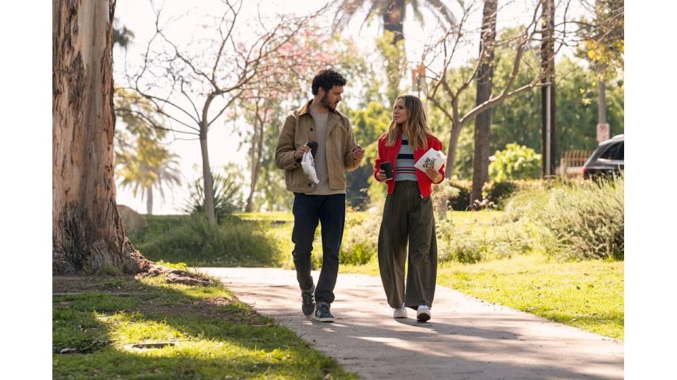 Kristen Bell wearing khaki trousers, striped top and red jacket on Nobody Wants This