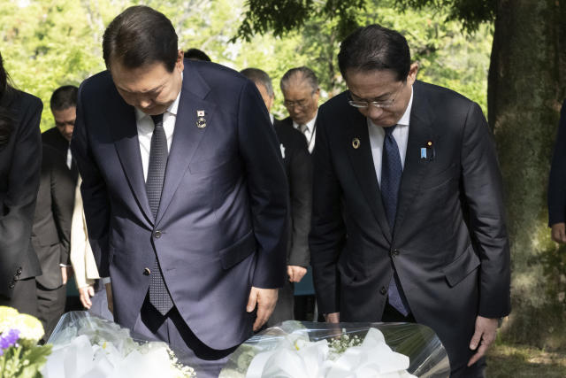 South Korea's President Yoon Suk Yeol, left, and Japan's Prime Minister Fumio Kishida bow as they lay flowers at the Monument in Memory of the Korean Victims of the A-bomb near the Peace Park Memorial in Hiroshima, western Japan Sunday, May 21, 2023, on the sidelines of the G7 Summit Leaders' Meeting. (Yuichi Yamazaki/Pool Photo via AP)