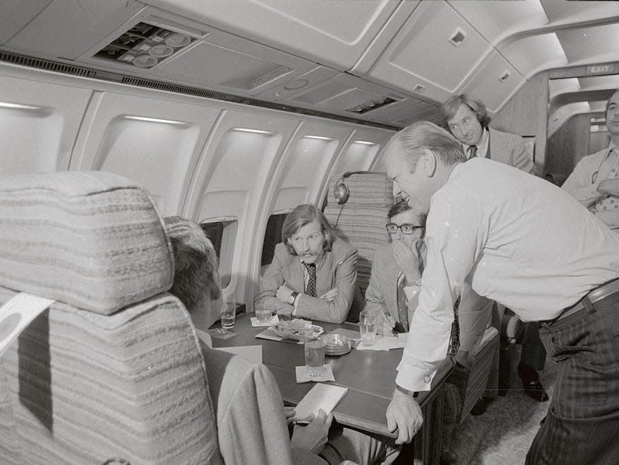 President Gerald Ford speaks to reporters on Air Force One.