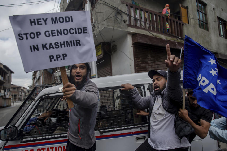 FILE - In this May 19, 2018, file photo, supporters of separatist People's Political Party (PPP) leader Hilal Ahmad War hold banners and shout slogans during a protest against the visit of Indian Prime Minister Narendra Modi in Srinagar, Indian controlled Kashmir. Modi’s vision of a Hindu India took a leap forward with his government’s decision in August, 2019, to subsume Kashmir into the federal government by eliminating its special status and allowing anyone to buy property and move into the state, raising fears among residents that they will lose their distinct identity. Modi’s home minister, Amit Shah, considered the architect of the Hindu nationalist-led government’s aggressive agenda to convert India from a secular, multicultural democracy into a distinctly Hindu, culturally and politically homogenous state, sold the new policy on Kashmir to parliament by equating it with Pakistan, India’s staunch foe. (AP Photo/Dar Yasin, File)