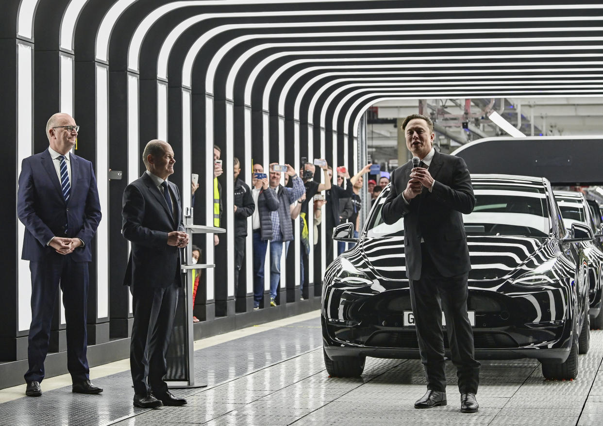 German Chancellor Olaf Scholz, Dietmar Woidke, Minister President of the State of Brandenburg, and Elon Musk, Tesla CEO, from left, attend the opening of the Tesla factory Berlin Brandenburg in Gruenheide, Germany, Tuesday, March 22, 2022. The first European factory in Gr'nheide, designed for 500,000 vehicles per year, is an important pillar of Tesla's future strategy. (Patrick Pleul/Pool via AP)