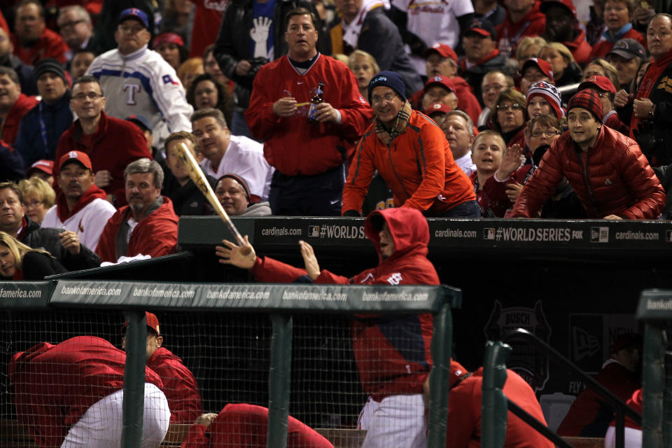 ST LOUIS, MO - OCTOBER 27: A baseball bat flies into the dugout during Game Six of the MLB World Series between the Texas Rangers and the St. Louis Cardinals at Busch Stadium on October 27, 2011 in St Louis, Missouri. (Photo by Ezra Shaw/Getty Images)