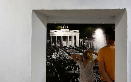 Visitors watch the exhibition entitled 'Hitler - How Could it Happen?' about German Nazi leader Adolf Hitler during a media tour in a World War Two bunker in Berlin, Germany, July 27, 2017. REUTERS/Fabrizio Bensch