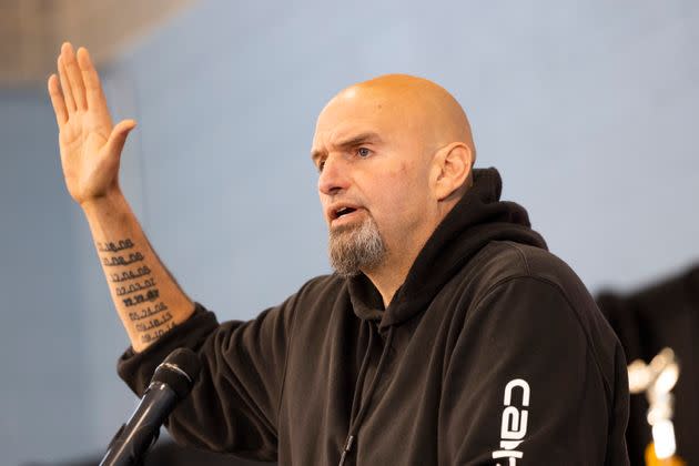 Pennsylvania Lt. Gov. John Fetterman (D) speaks in Philadelphia on Saturday. The tattoos on his left arm mark the dates of nine violent deaths that took place in Braddock during his mayoralty. He says he is proud of also presiding over a five-year period without any murders. (Photo: Ryan Collerd/Associated Press)