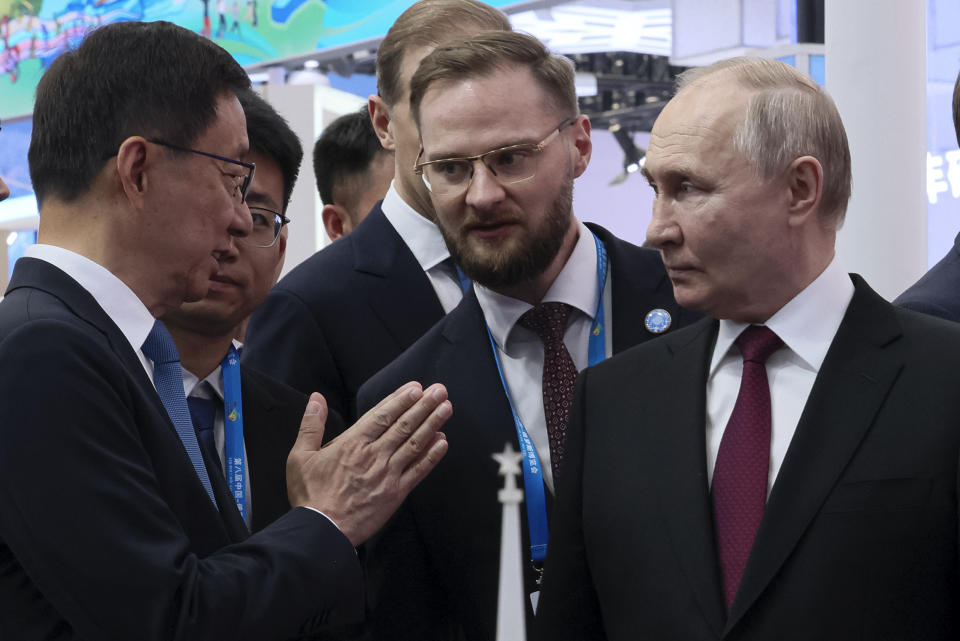 Russian President Vladimir Putin, right, and Chinese Vice President Han Zheng talk to each other as they visit the Russian-Chinese EXPO in Harbin in northeastern China's Heilongjiang Province, on Friday, May 17, 2024. (Mikhail Metzel, Sputnik, Kremlin Pool Photo via AP)