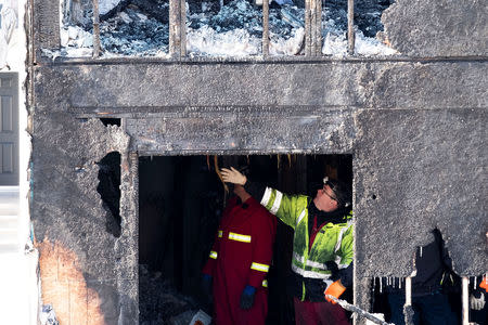 Police and fire invetsigators are on the scene of a fatal house fire in the community of Spryfield in Halifax, Nova Scotia, Canada, February 19, 2019. REUTERS/Ted Pritchard