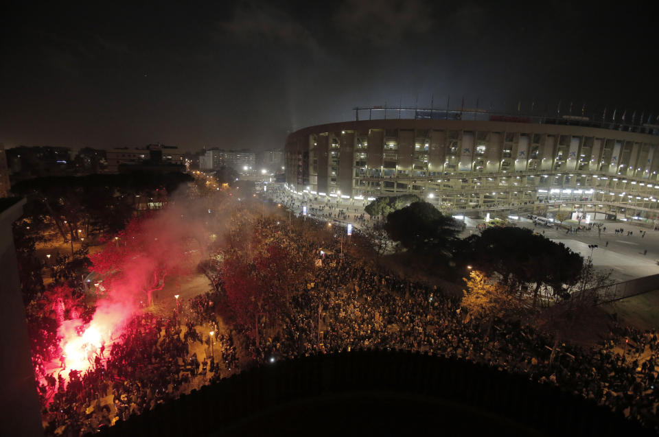 Catalan pro-independence demonstrators and Barcelona supporters gather outside the Camp Nou stadium ahead of a Spanish La Liga soccer match between Barcelona and Real Madrid in Barcelona, Spain, Wednesday, Dec. 18, 2019. Thousands of police and private security personnel were deployed Wednesday in and around Barcelona's Camp Nou stadium to ensure that a protest over Catalonia's separatist movement does not disrupt one of the world's most-watched soccer matches. (AP Photo/Joan Mateu)