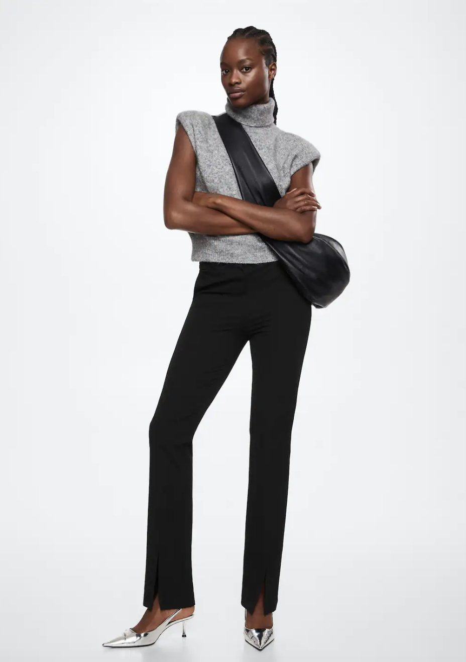 model wearing grey sleeveless sweater and black Slit Hem Trousers (photo via Mango)