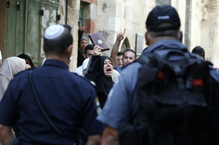 A Palestinian woman from the so-called Murabitat group holds a copy of the Koran during a protest against Jewish groups visiting the Al-Aqsa mosque compound in Jerusalem's Old City on September 16, 2015