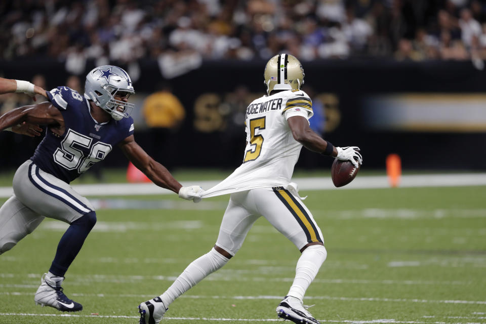 Dallas Cowboys defensive end Robert Quinn (58) sacks New Orleans Saints quarterback Teddy Bridgewater (5)in the first half of an NFL football game in New Orleans, Sunday, Sept. 29, 2019. (AP Photo/Bill Feig)