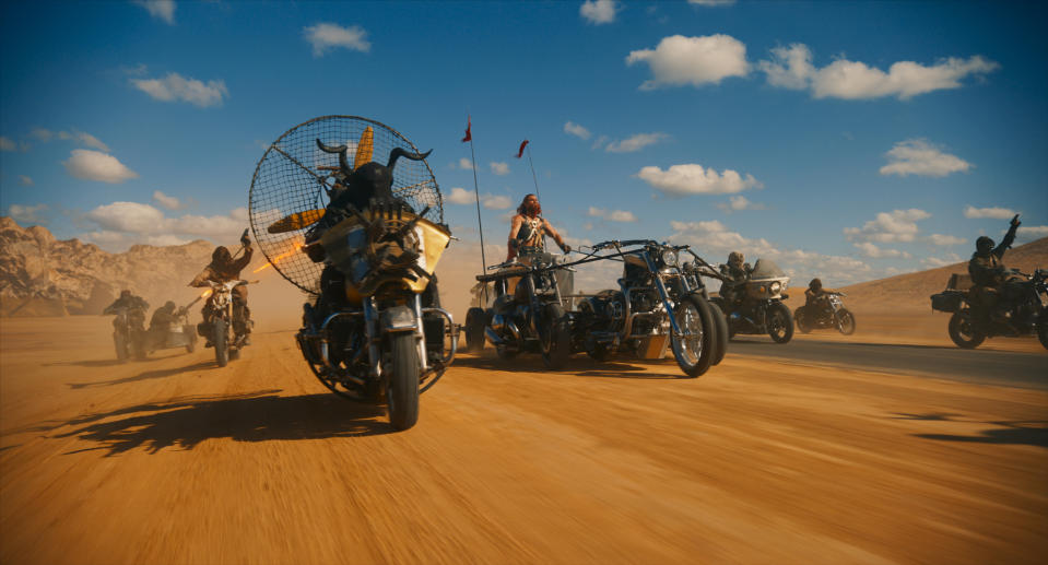 Chris Hemsworth, center, rides a chariot of motorcycles in ‘Furiosa.’