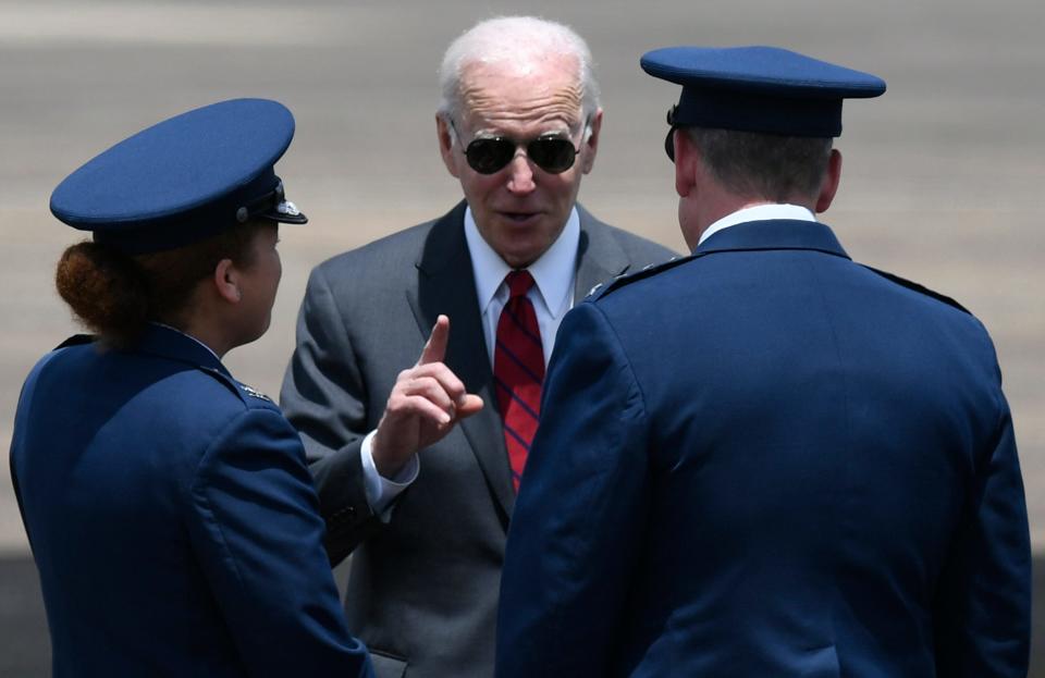 President Joe Biden talks with Col. Eries Mentzer, 42nd AirBase Wing Commander, left, and Lt. Gen. James Hecker, Air University Commander and President, as he arrives on Air Force One at Maxwell Air Force Base in Montgomery, Ala., on his way to visit the Lockheed Martin facility in Troy, Ala., on Tuesday May 3, 2022.