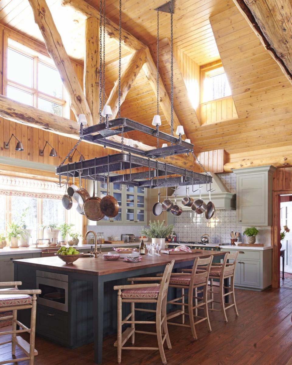 a kitchen with wooden floors and very tall ceilings that are wood too