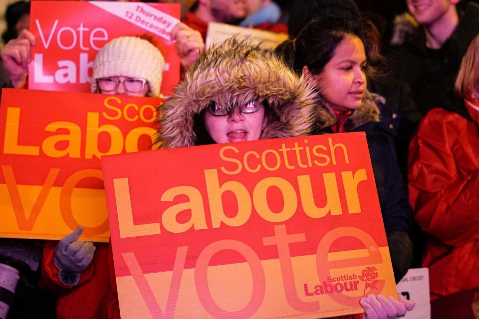 Supporters hold placards as Labour Leader Jeremy Corbyn delivers a stump in Govan (Getty Images)