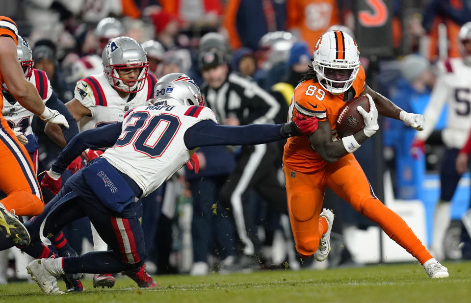 FILE -New England Patriots linebacker Marte Mapu (30) tries to tackle Denver Broncos wide receiver Brandon Johnson (89) in the second half of an NFL football game in Empower Field at Mile High Sunday, Dec. 24, 2023, in Denver. Playing for multiple schools no longer raises a red flag for NFL talent evaluators in this day and age of the ever busier transfer portal and increasingly eye-popping financial windfalls available to college football players before they're even old enough to buy a round of drinks. (AP Photo/Geneva Heffernan, File)