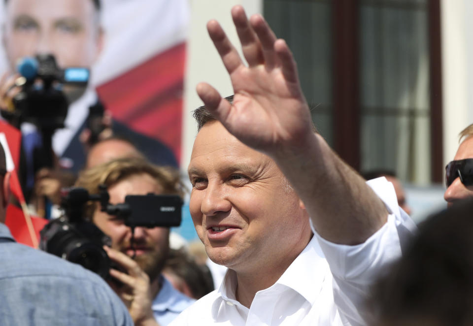 Polish President Andrzej Duda waves to supporters as he campaigns for a second term in Serock, Poland, on Wednesday, June 17, 2020, Duda is the frontrunner ahead of the election on Sunday, June 28, but is not expected to reach the 50% threshold needed to win outright. That will require a runoff two weeks later in which he is expected to face off against Warsaw Mayor Rafal Trzaskowski in a very close race.(AP Photo/Czarek Sokolowski)