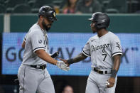 Chicago White Sox's Jose Abreu, left, and Tim Anderson celebrate after Anderson scored on a sacrifice fly by Abreu during the first inning of the team's baseball game against the Texas Rangers in Arlington, Texas, Friday, Sept. 17, 2021. (AP Photo/Tony Gutierrez)