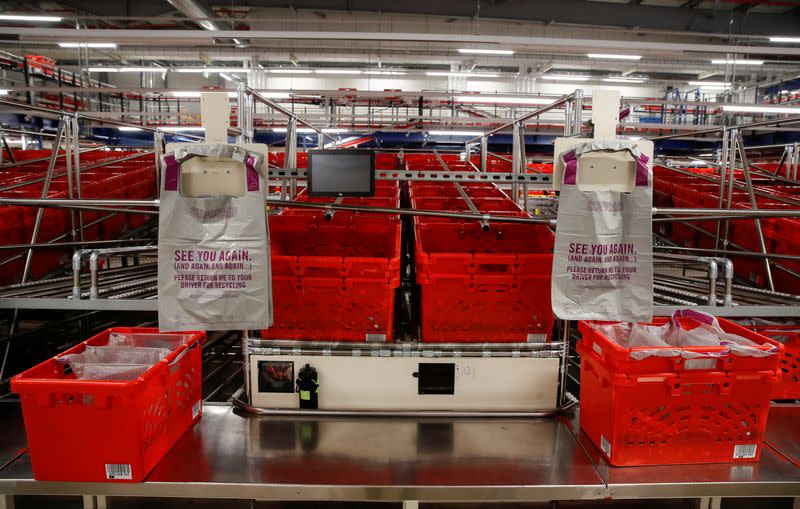 Ocado robots are seen inside a warehouse in Erith