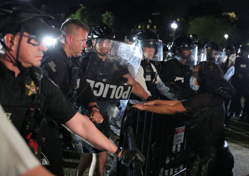 Una mujer confronta a los oficiales de la división uniformada del Servicio Secreto de los Estados Unidos que mantienen un perímetro alrededor de la Casa Blanca, en Washington